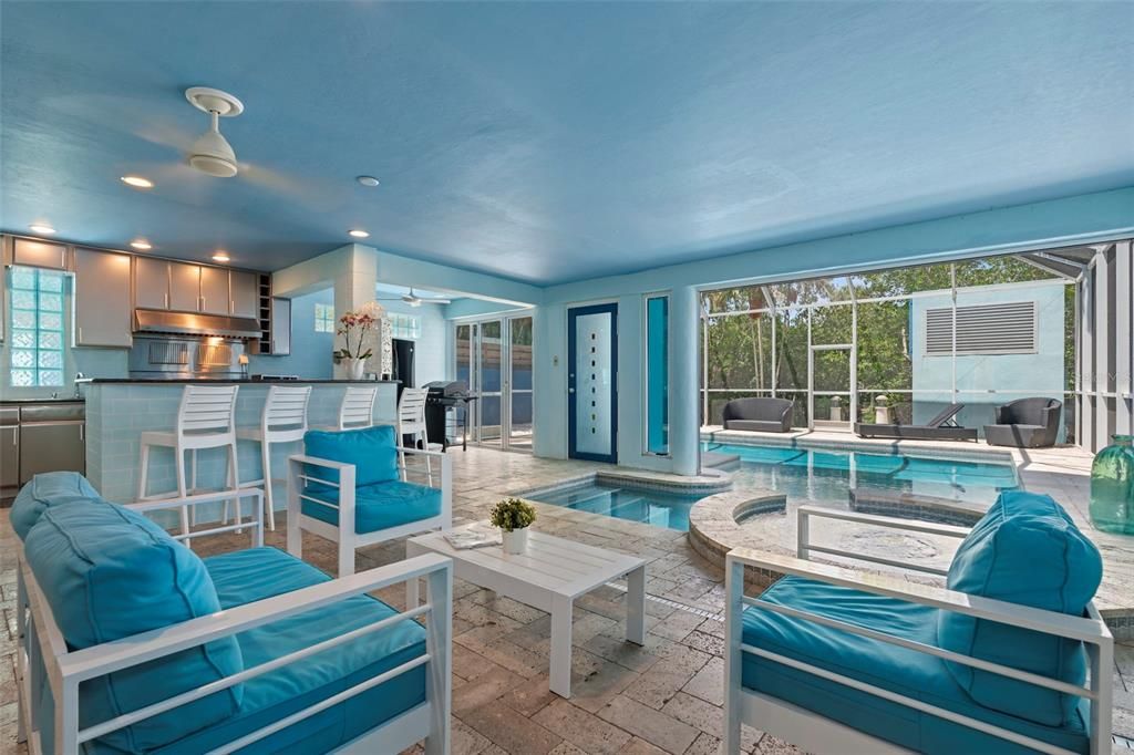 The first level features an indoor/outdoor swimming pool and spa, screened-in lounge area and full outdoor kitchen with stainless appliances and gas range making it the perfect place for family fun and entertaining.