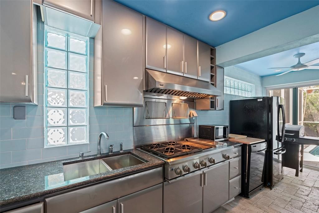 The first level features an indoor/outdoor swimming pool and spa, screened-in lounge area and full outdoor kitchen with stainless appliances and gas range making it the perfect place for family fun and entertaining.