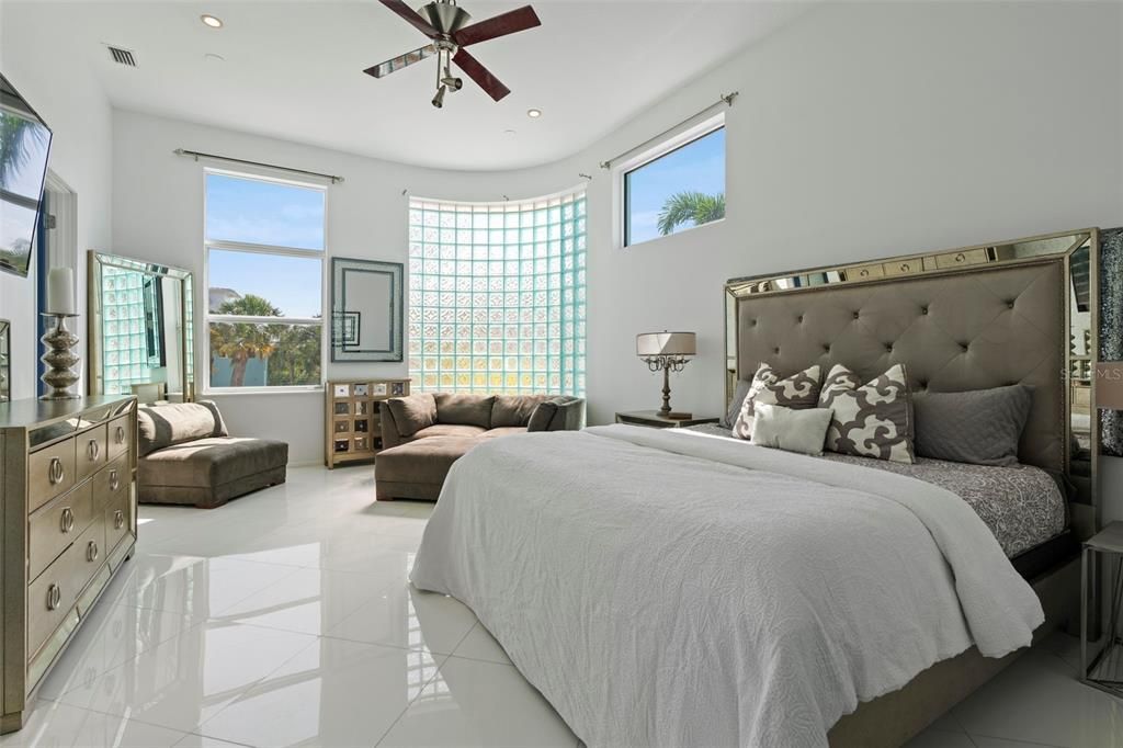 Relax in the private owner's suite bathed in light through the glass block wall feature and luxuriate in the owners spa-like bath with jetted tub, gorgeous granite counters, etched glass, and Toto toilet system.