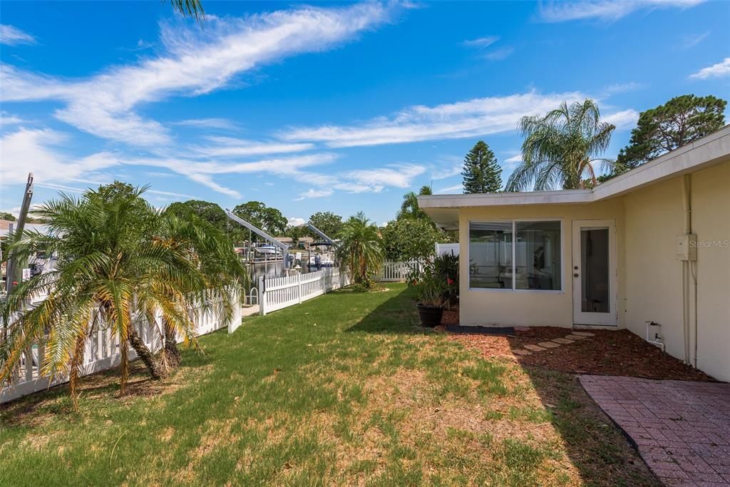 The spacious Vinyl fenced-in backyard provides ample room for outdoor activities and offers privacy and security, completing the perfect coastal living experience.