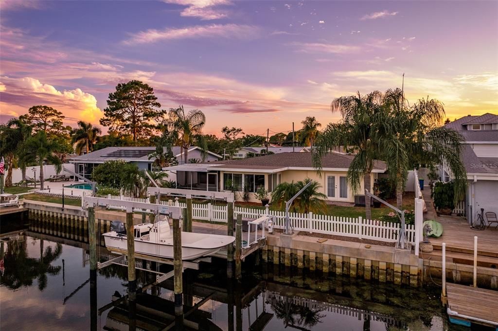 Experience the breathtaking sunset over this coastal paradise home, where every evening paints the sky with vibrant hues, casting a mesmerizing glow over the tranquil waterfront setting.