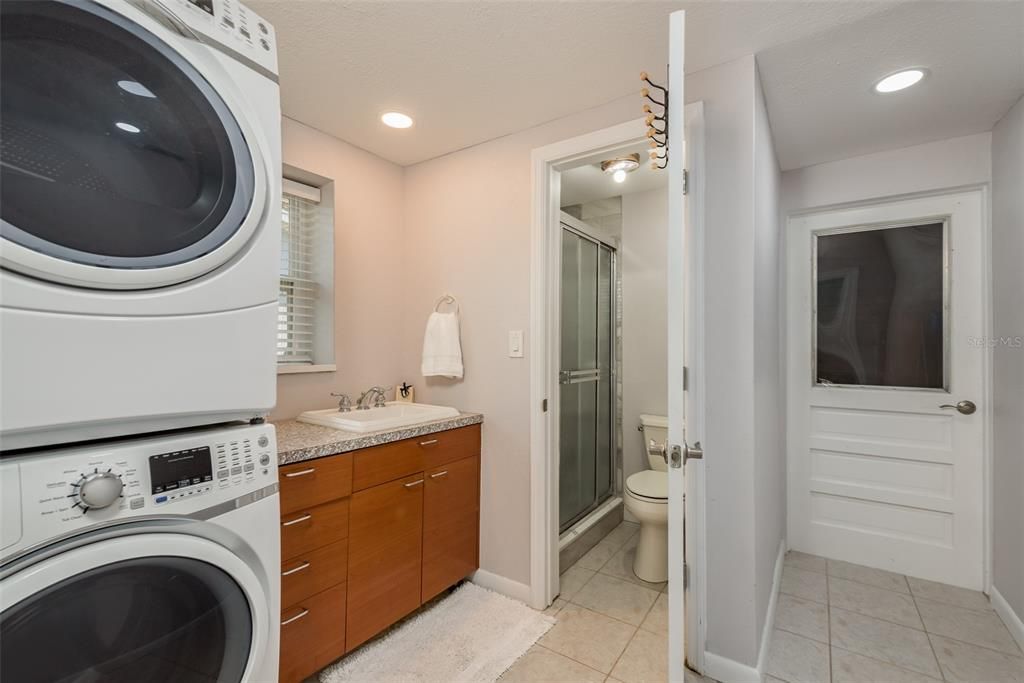 Bathroom 2, situated in the third bedroom, boasts updated vanity and countertops, complemented by sleek ceramic tile floors and a luxurious walk-in shower, offering both style and comfort.