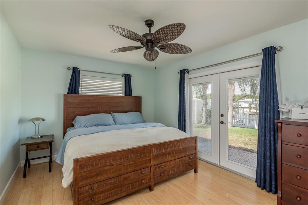 The primary bedroom exudes luxury with built-in closets and elegant French doors that showcase scenic water views, allowing you to enjoy the beauty right from your bed.