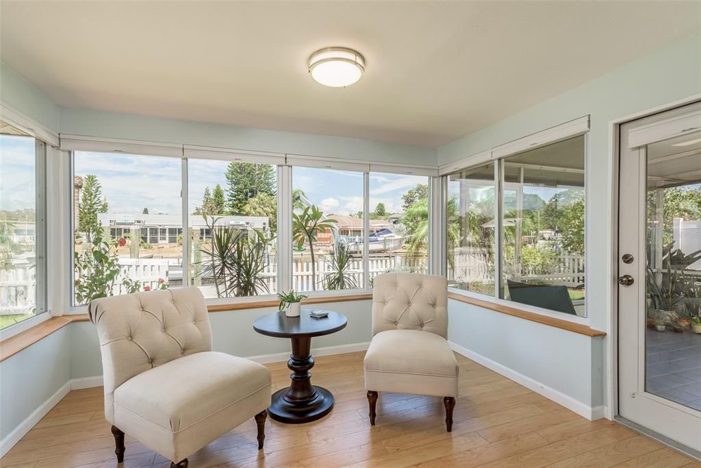 Exiting the third bedroom, you step into the cozy sitting/dining area, where unobstructed views of the ocean await, providing a serene and captivating backdrop for relaxation and dining.