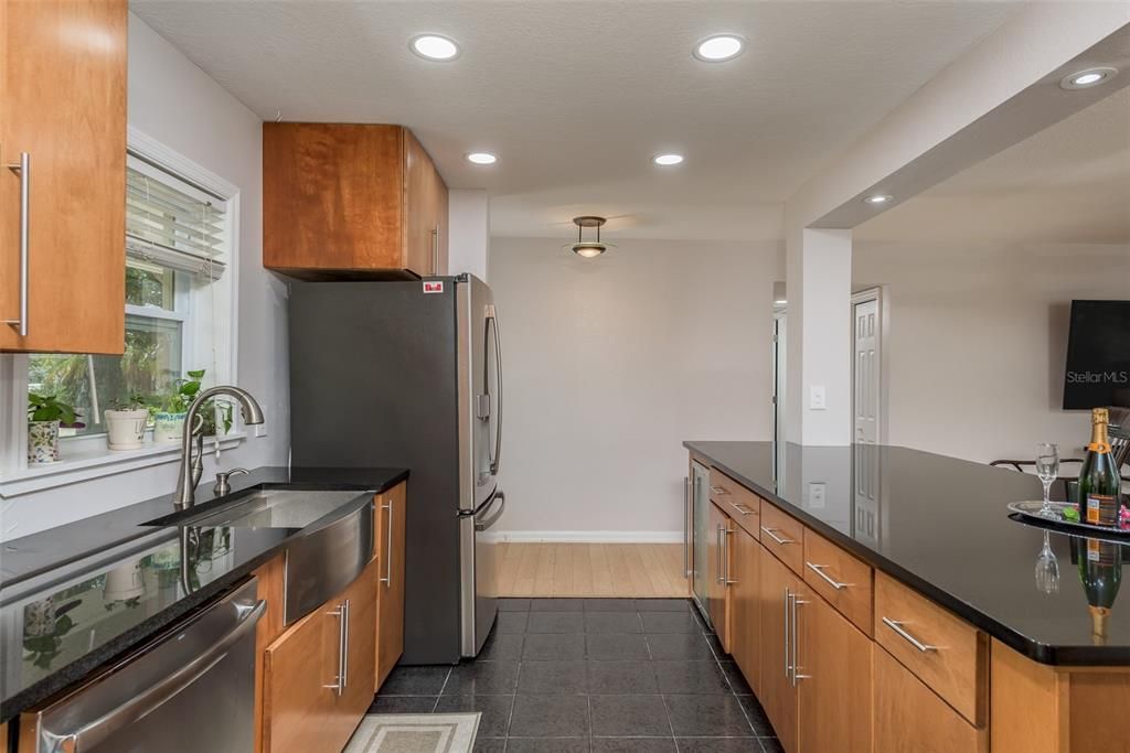 kitchen also features a farmhouse sink with a picturesque window above, perfectly framing serene views.