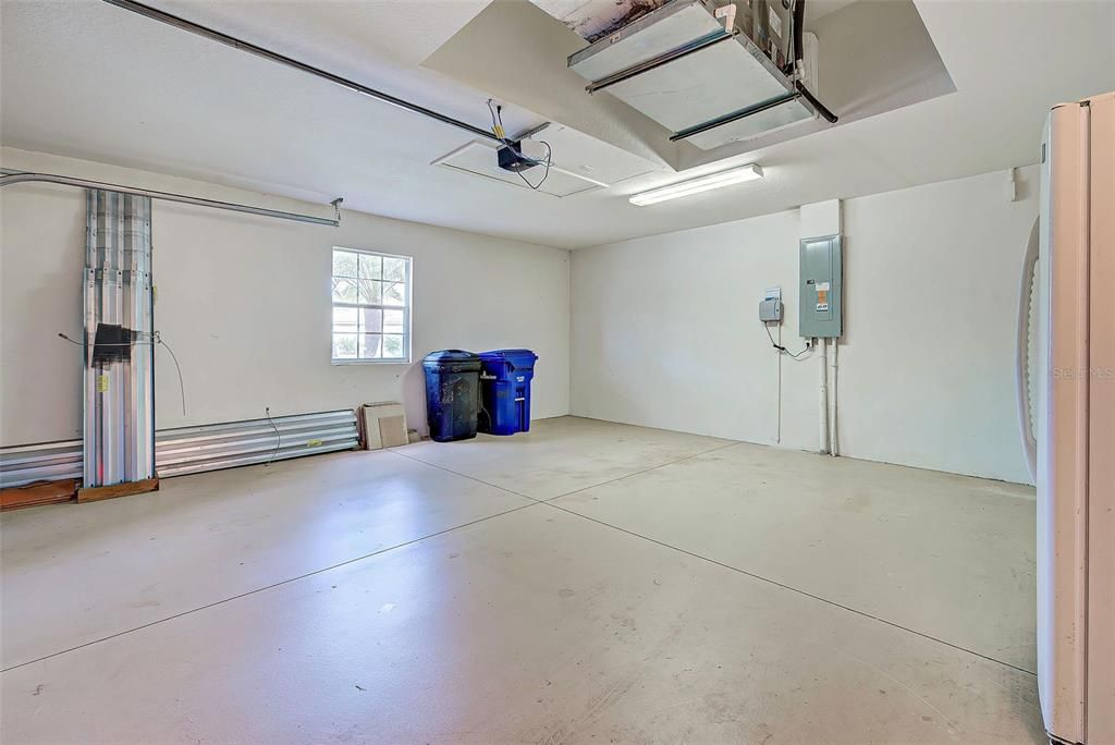 The garage is very clean and large.  Notice the storm shutters stored in it.