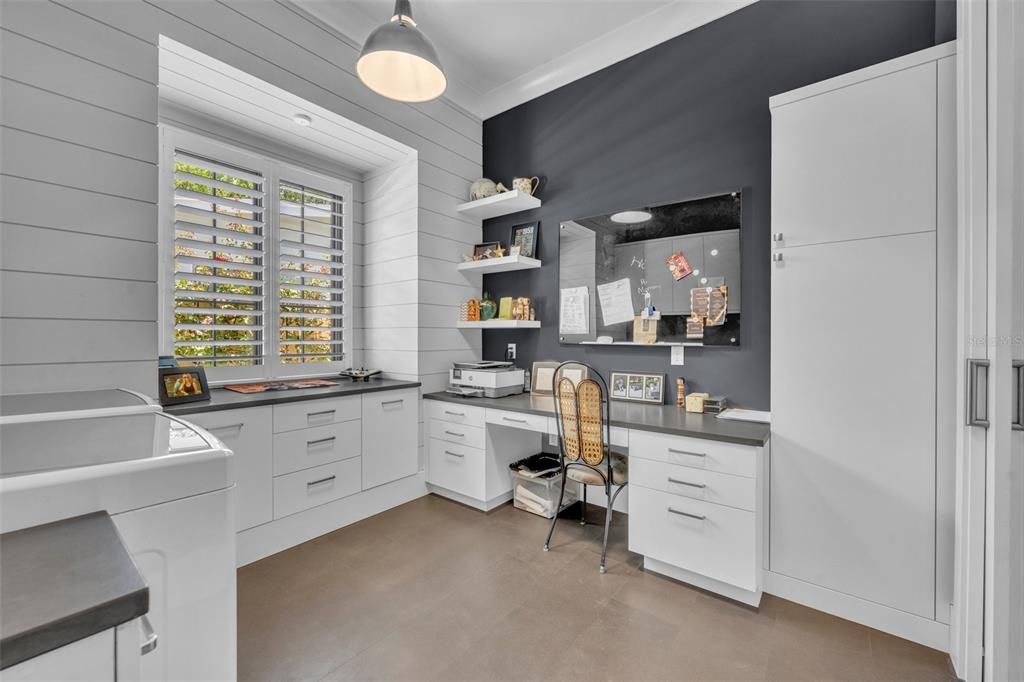 Spacious laundry room with a built-in desk