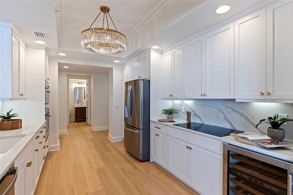 Kitchen with new quartz countertops, flooring, convection oven, and wine refrigerator