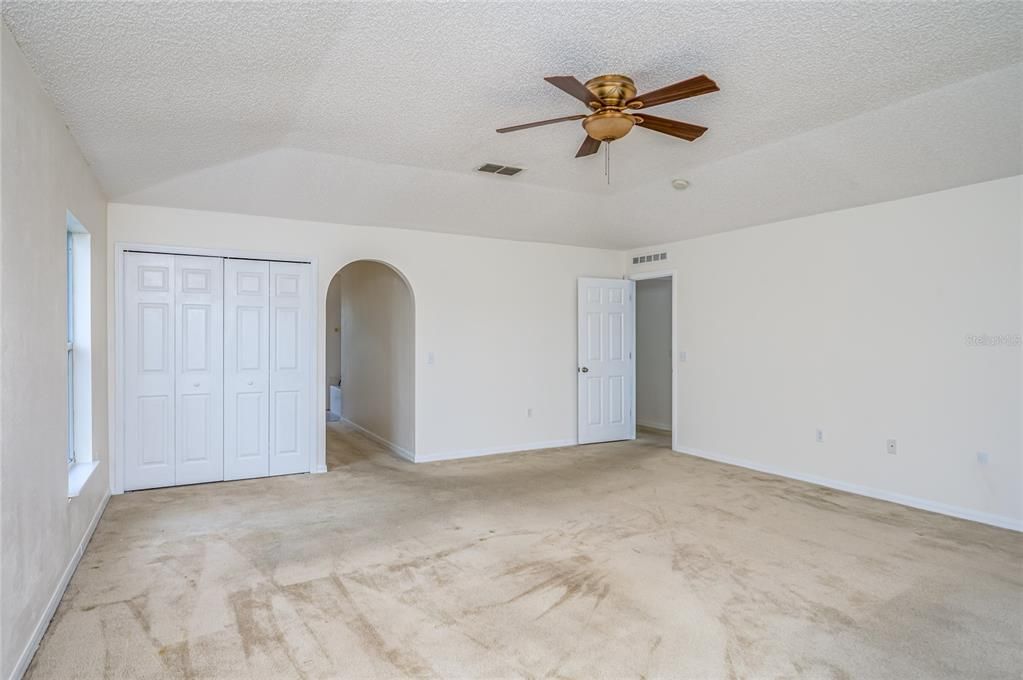 primary bedroom features 2 walk in closets on the way to bathroom