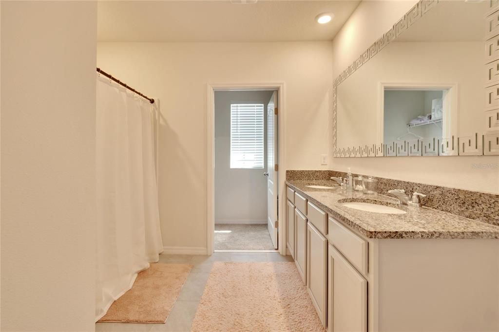 Uptairs guest bathroom with bath and shower ombo and double vanities