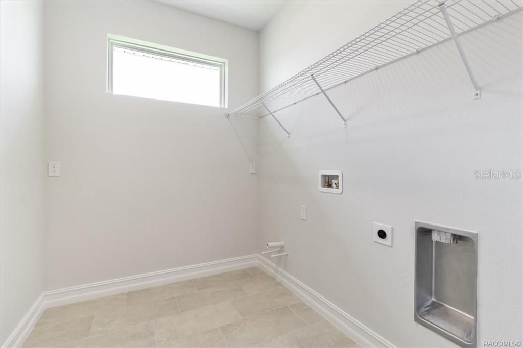 Hallway facing front entrance has coat closet