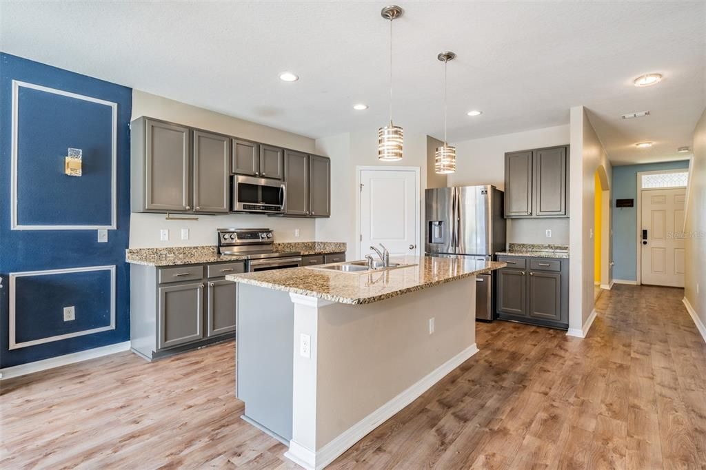 Gleaming Granite counters and pendant lites in this gorgeous kitchen