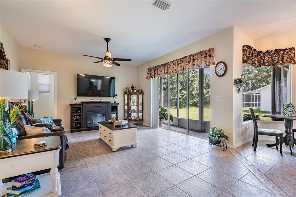 Tile floors in this Great room witj serene conservation views