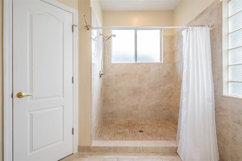 Large step in shower with natural light