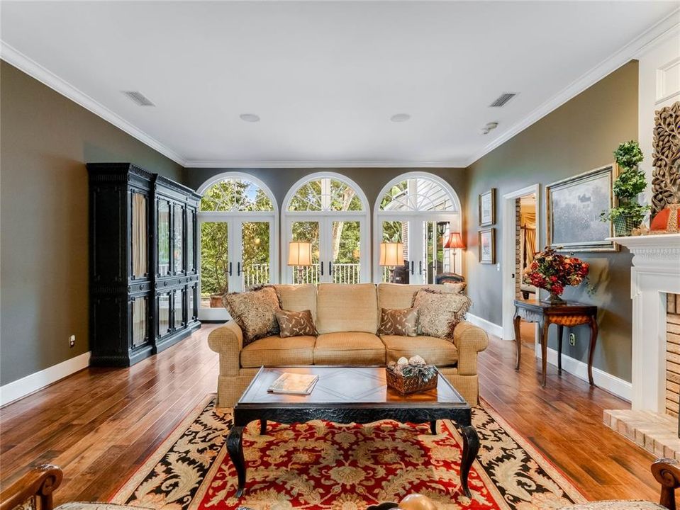 Living room looking out to the private backyard and pool.