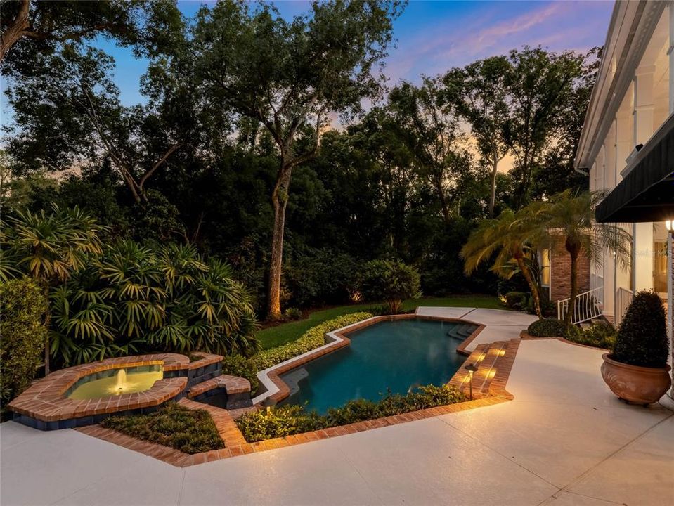 Twilight of the back of the home and pool.