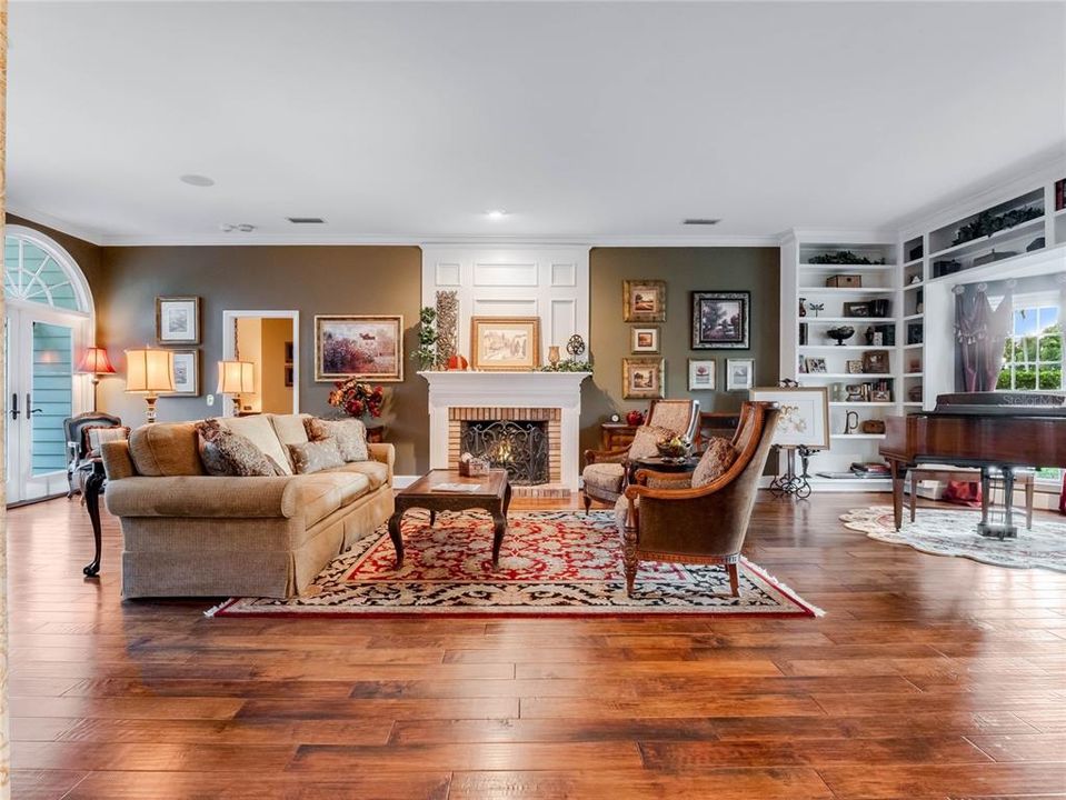 Living room with fireplace and the door to the downstairs primary suite.