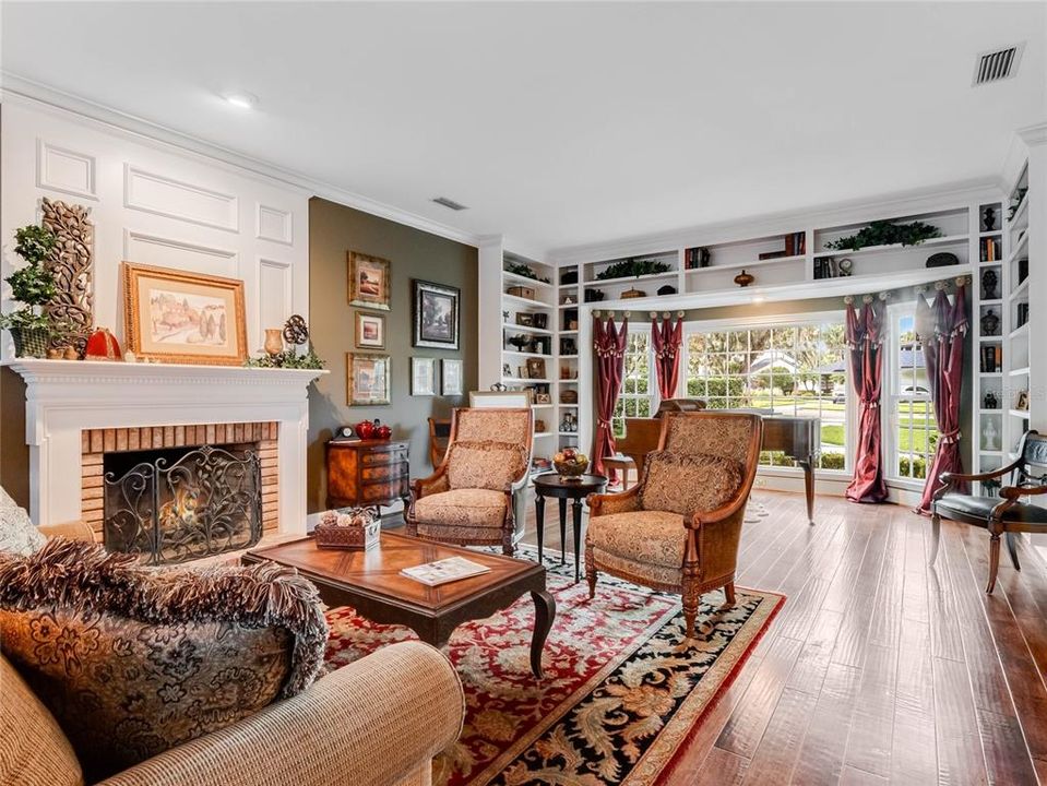 Living room with fireplace and grand piano.