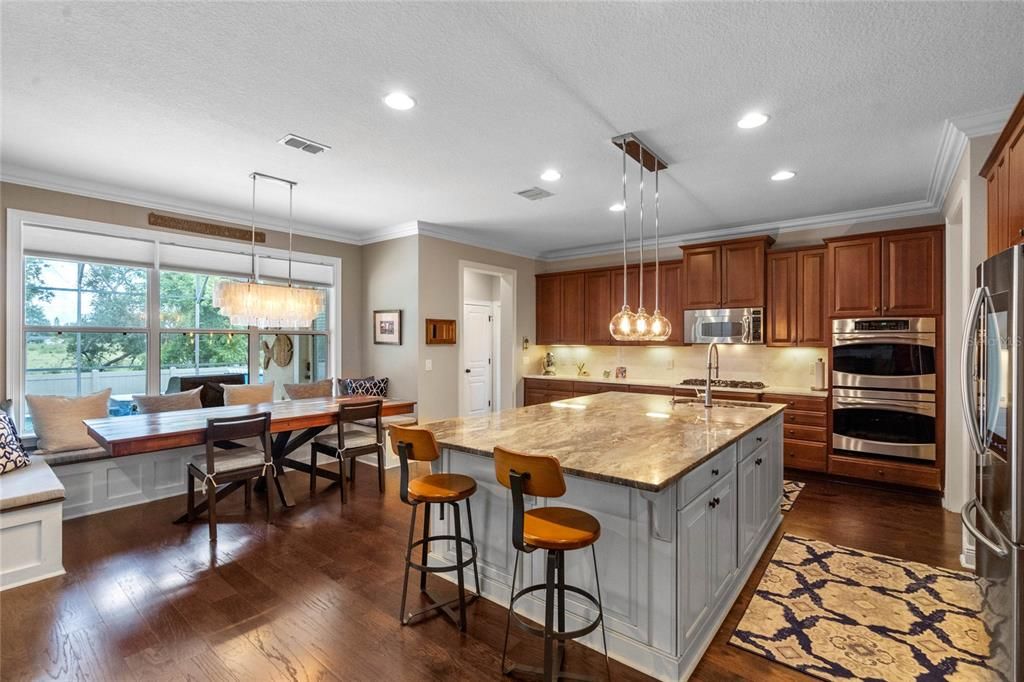 kitchen has quartz countertops, stainless steel appliances, built-in ovens, a gas cooktop, a wifi-enabled smart refrigerator