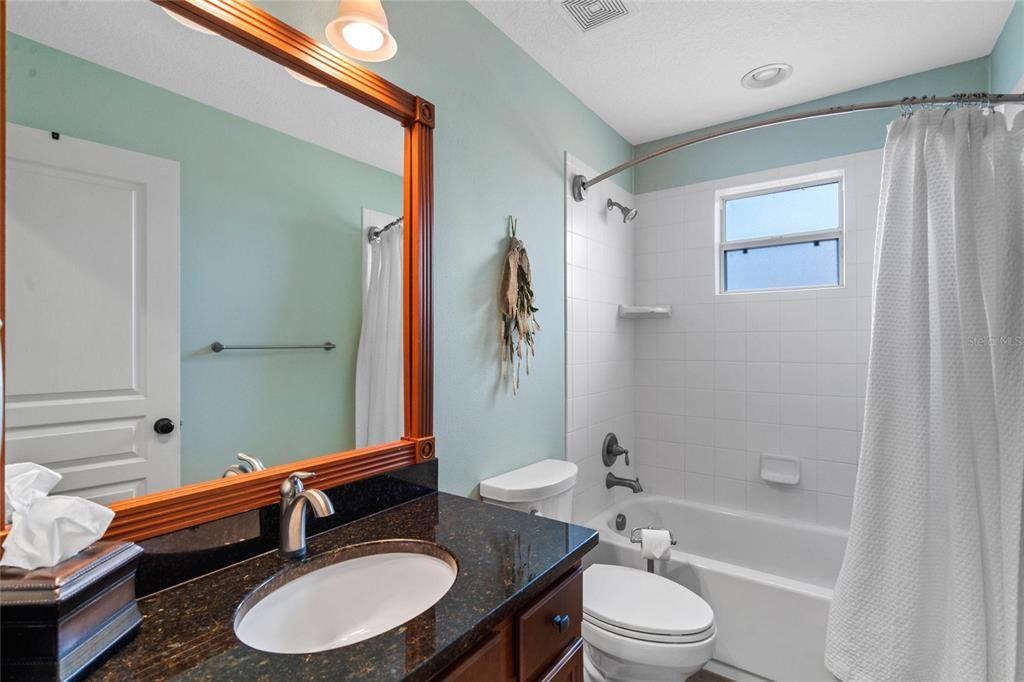 other bathroom with single sink vanity area, a shower and a tub