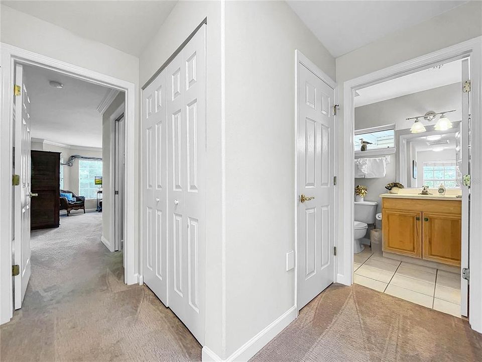 Hallway leading to Primary bedroom with linen closet shown in hallway