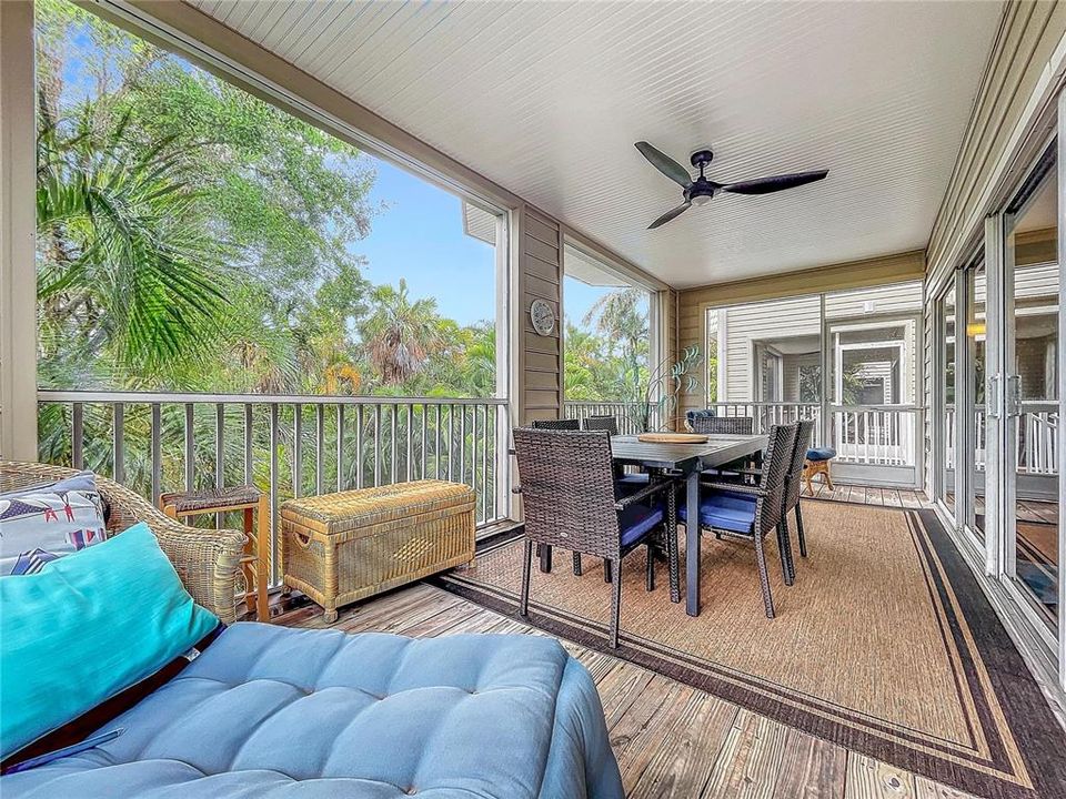 Large screened lanai with plenty of room for outdoor dining, conversation set and lounger