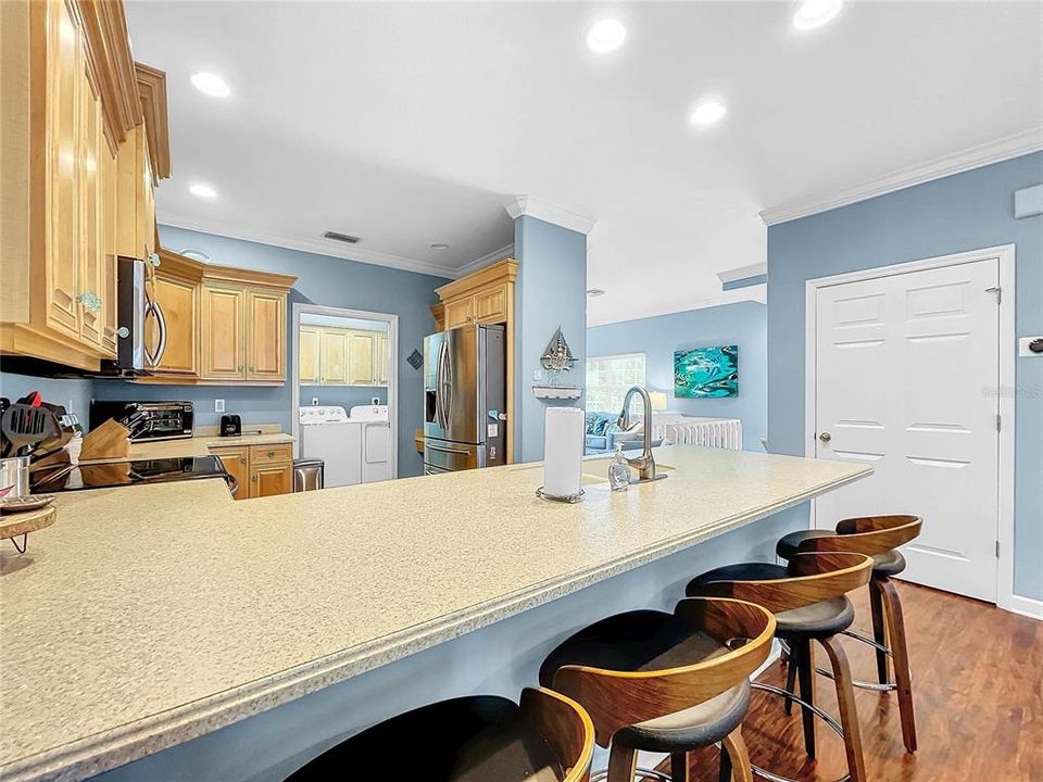 Kitchen bar seating  with a laundry room just off the kitchen