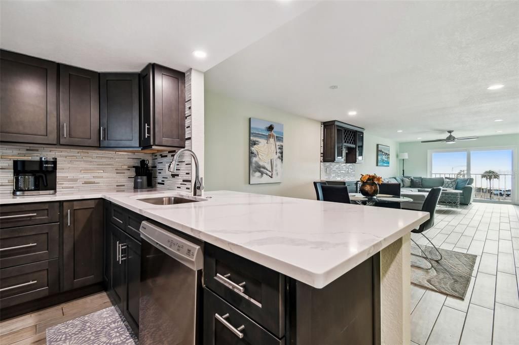 The large eat-in bar offers seating for 3 with sleek Quartz counters.