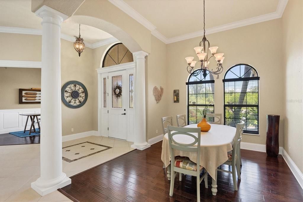 Sophisticated formal dining and entry area featuring stunning hardwood floors