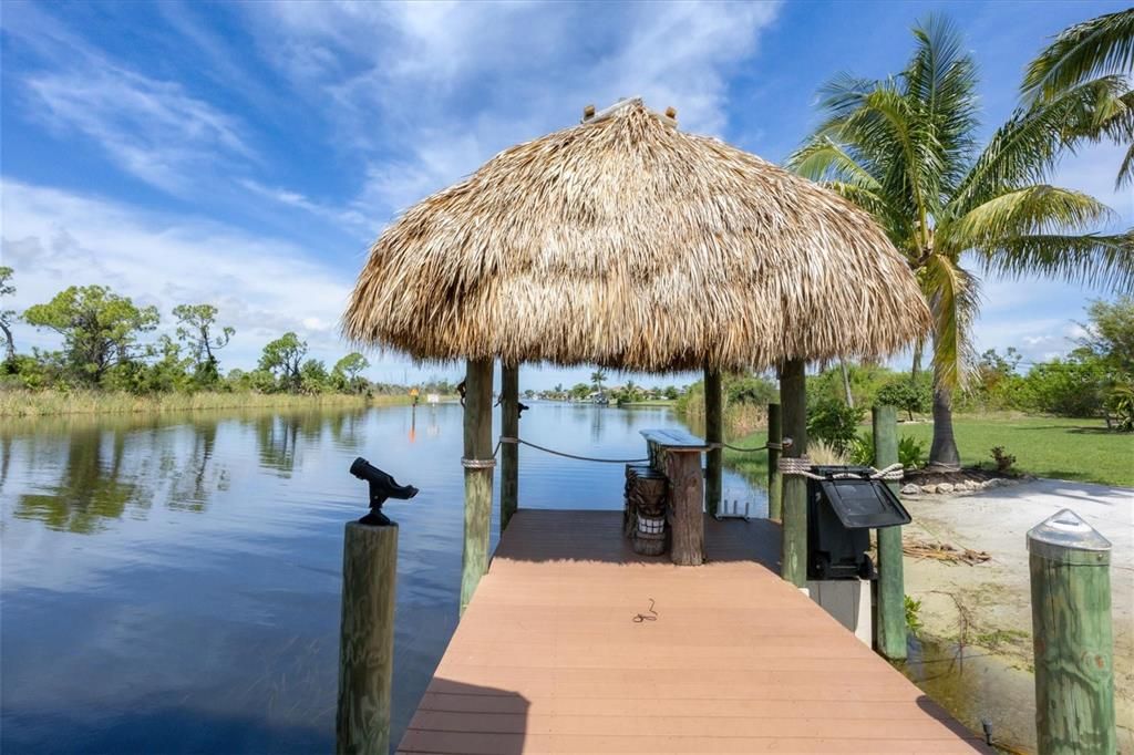 Secluded retreat with soft sand beaches, spacious dock with covered boat lift, and tiki bar