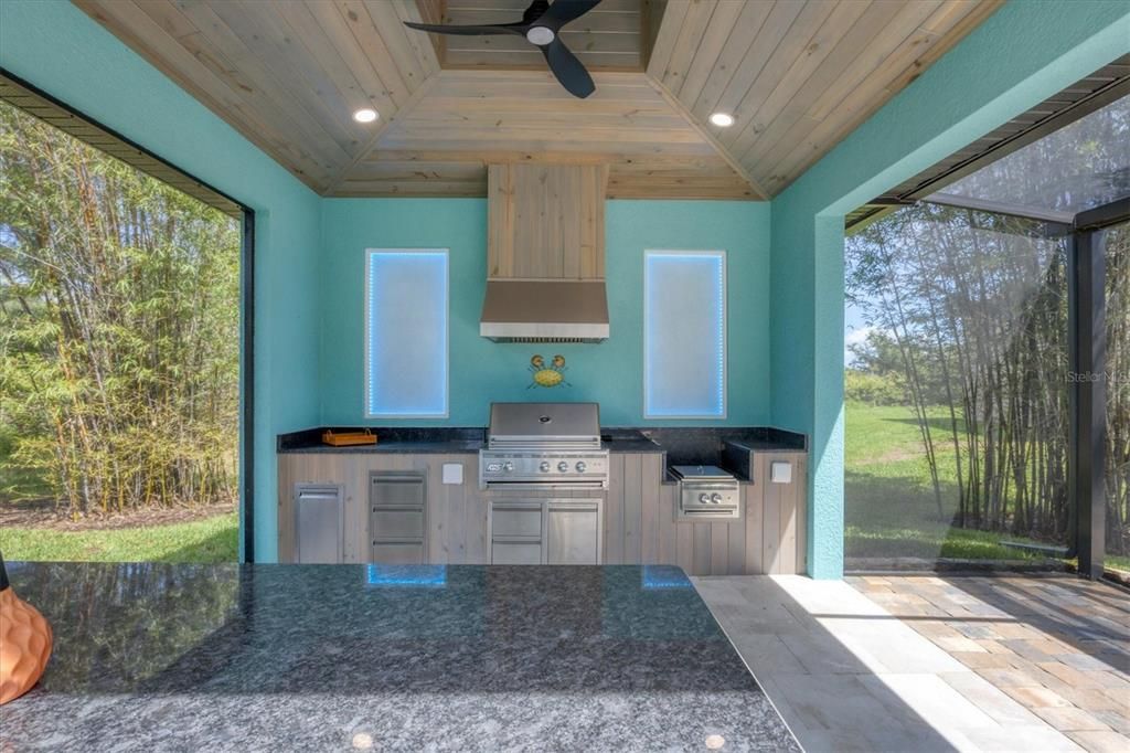 Expansive 14x14 outdoor kitchen with grill, LED lighting, and dedicated steaming stations