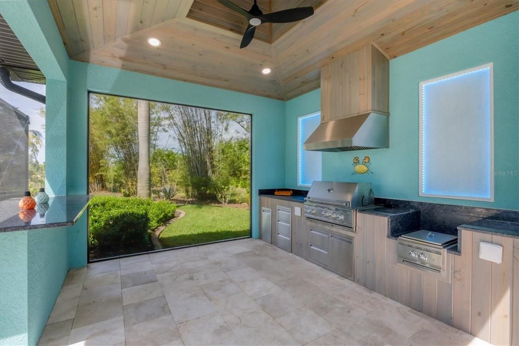 Expansive 14x14 outdoor kitchen with grill, LED lighting, and dedicated steaming stations