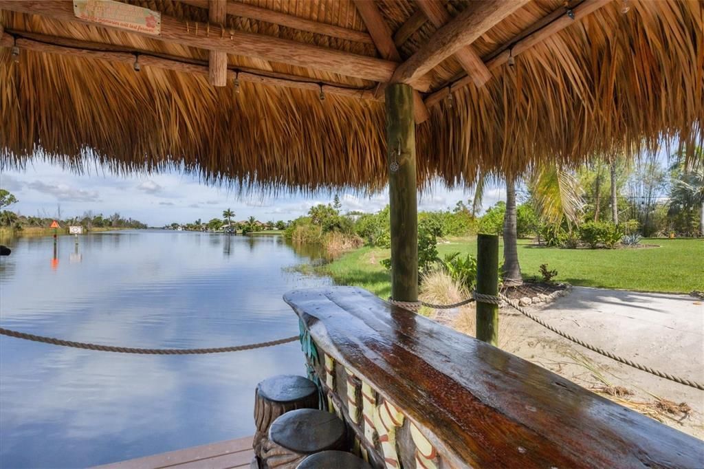 Secluded retreat with soft sand beaches, spacious dock with covered boat lift, and tiki bar