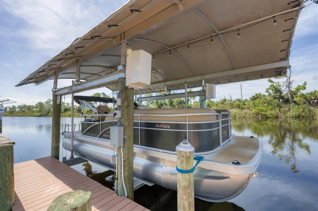 Secluded retreat with soft sand beaches, spacious dock with covered boat lift, and tiki bar