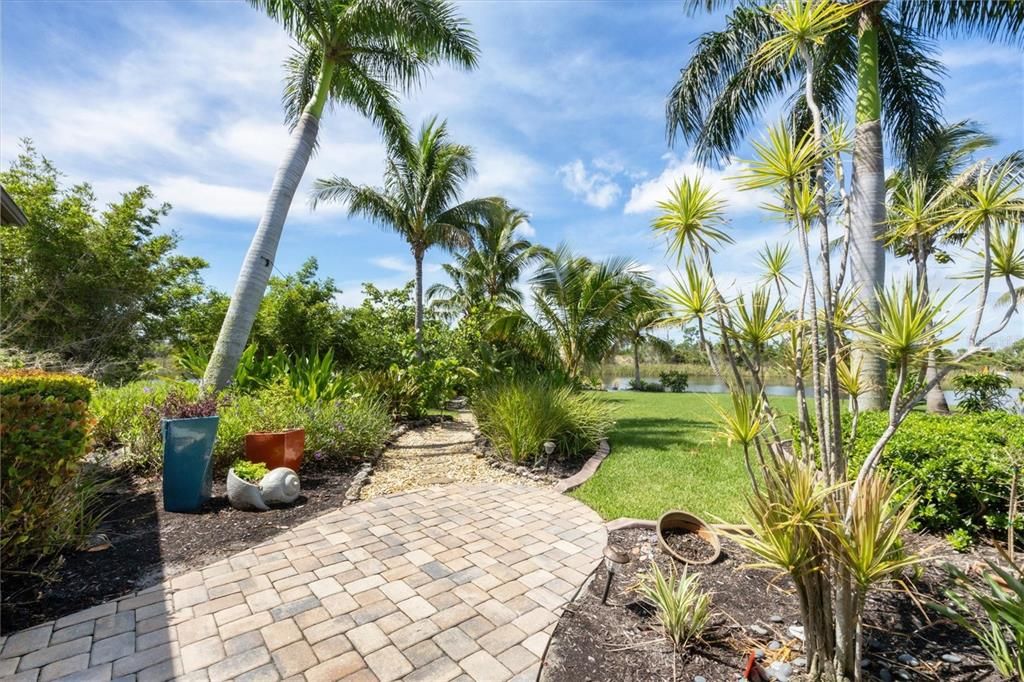 Picturesque landscaping featuring mature fruit trees and various hibiscus varieties