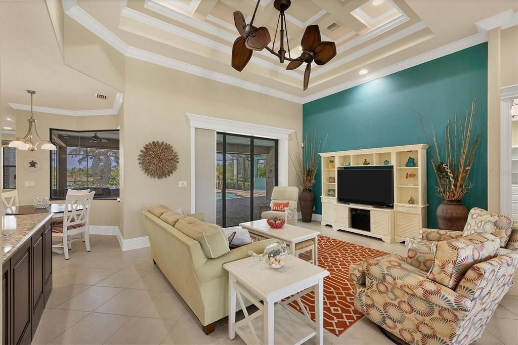 Inviting great room with elegant coffered ceilings, perfect for socializing and unwinding