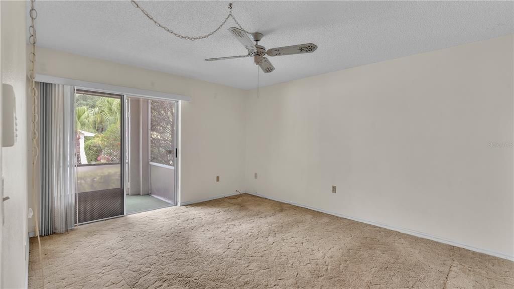 Master Bedroom with Access to the screened back porch and right to the pool and sitting area.