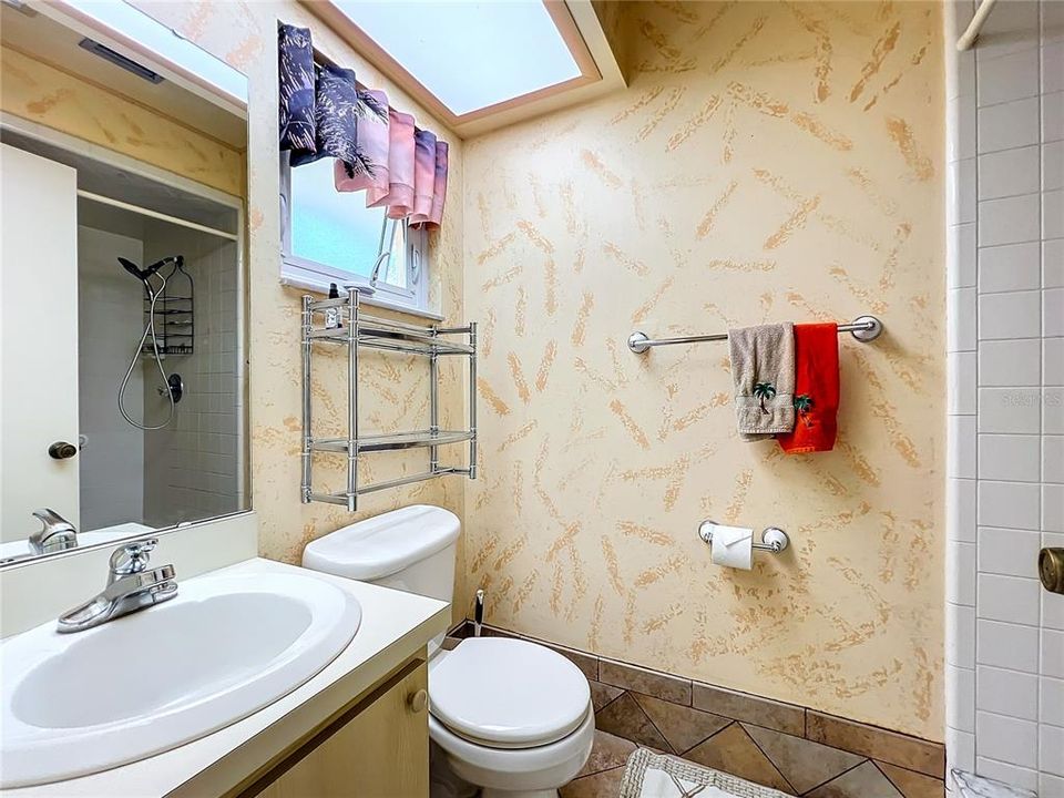 Full guest bathroom off of laundry just inside separate entrance.