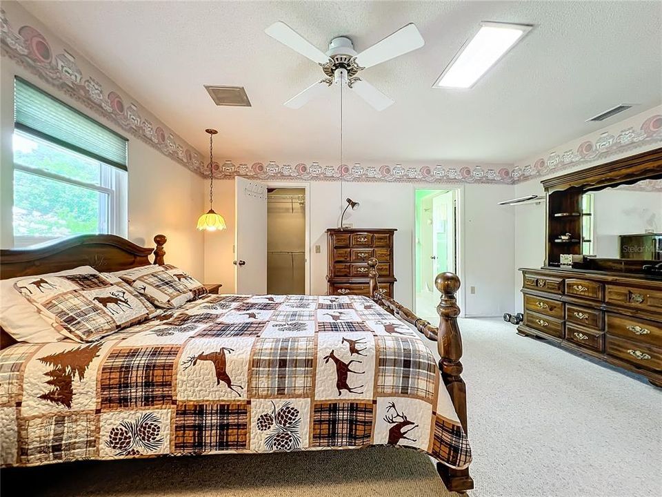 Primary bedroom with en suite bath and walk-in closet.