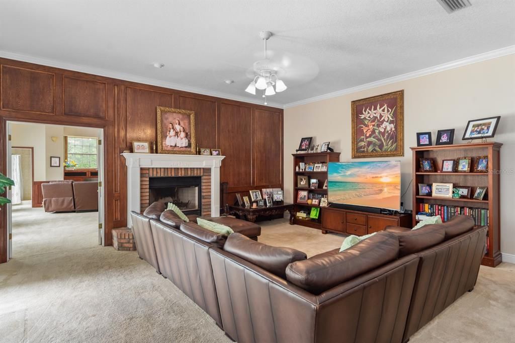 family room with wood paneling; view into playroom