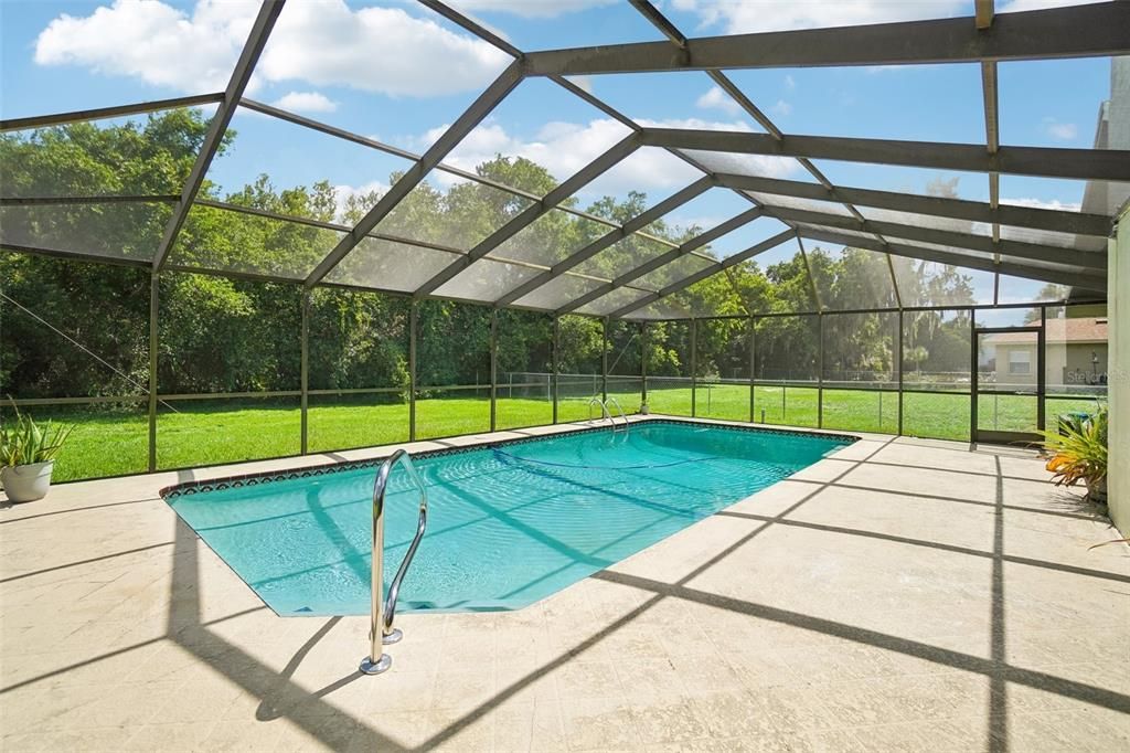 Large saltwater pool with new screened in cage and lanai.