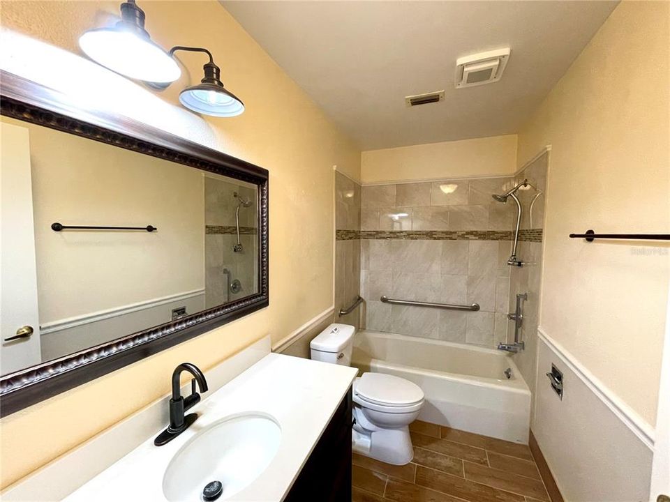 Master Bath has convenience features:  hand rails and hand held shower