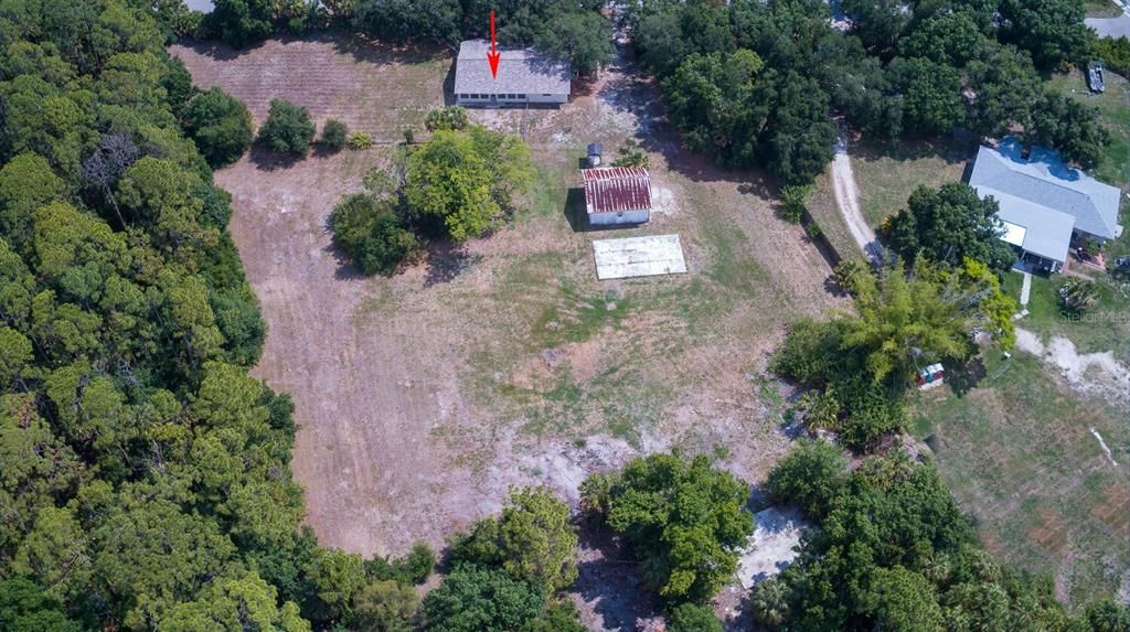 House, pole barn, cement pad and at tree line another cement pad