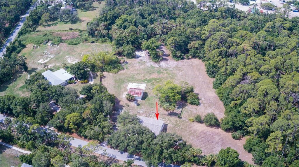 Note arrow to main home, then pole barn, then cement pad beside bar and at edge of woods the 2nd cement pad.