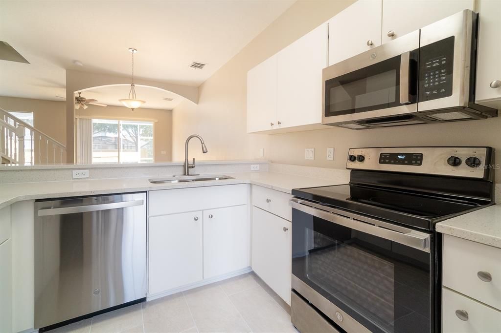 white cabinetry and stainless steel appliances