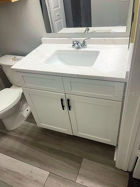 En suite primary bathroom with brand new solid wood vanity and quartz countertop