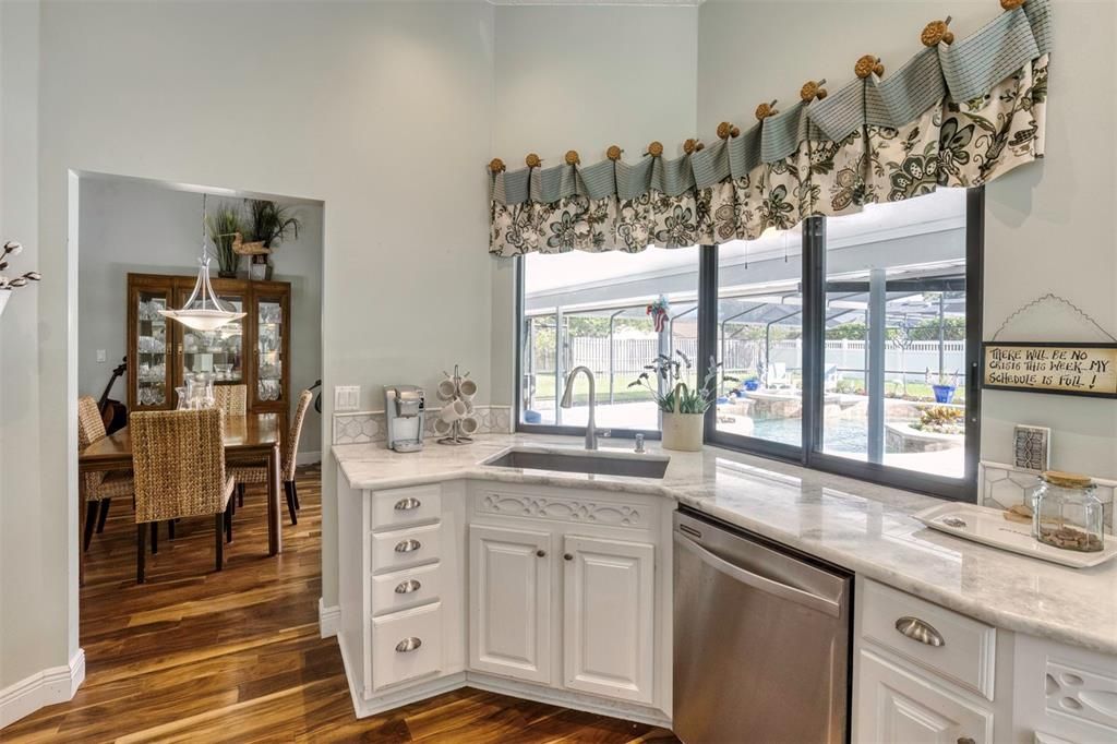 Kitchen  with full view of the pool area. Light and Bright