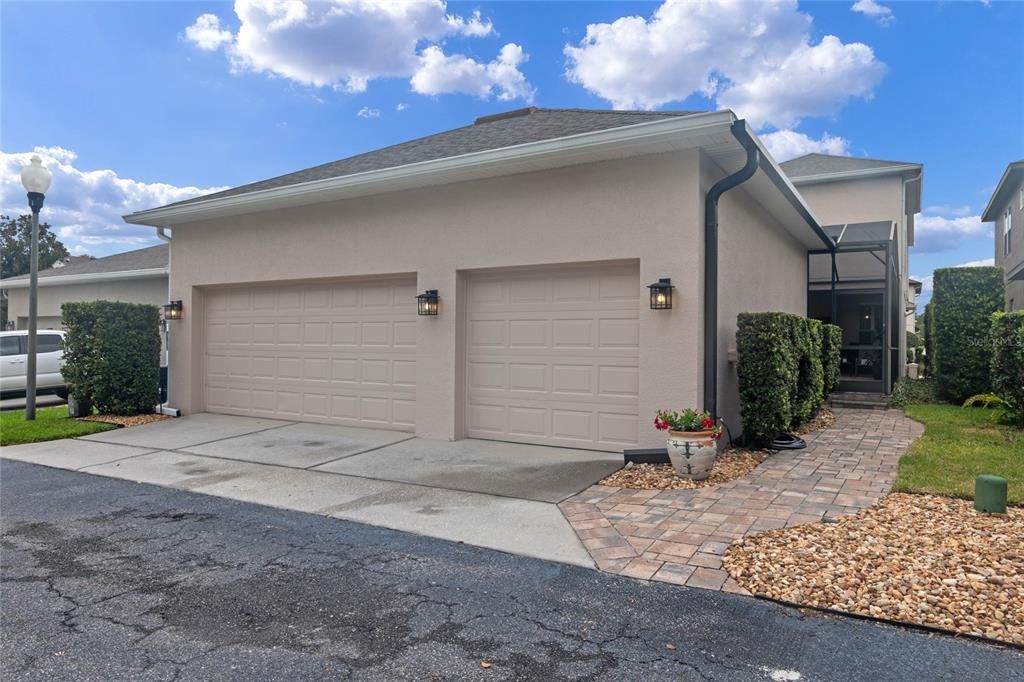 3 car garage with brick paver walkway