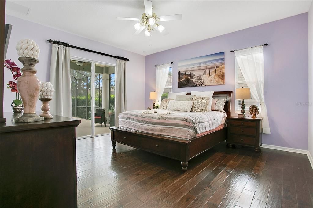 Primary Bedroom with Sliding Glass Doors that Open to Cover Screen Lanai