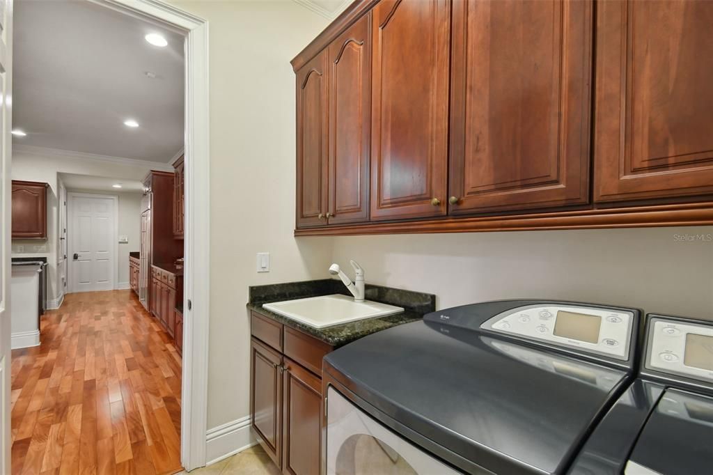 Laundry room with sink and built-in cabinets